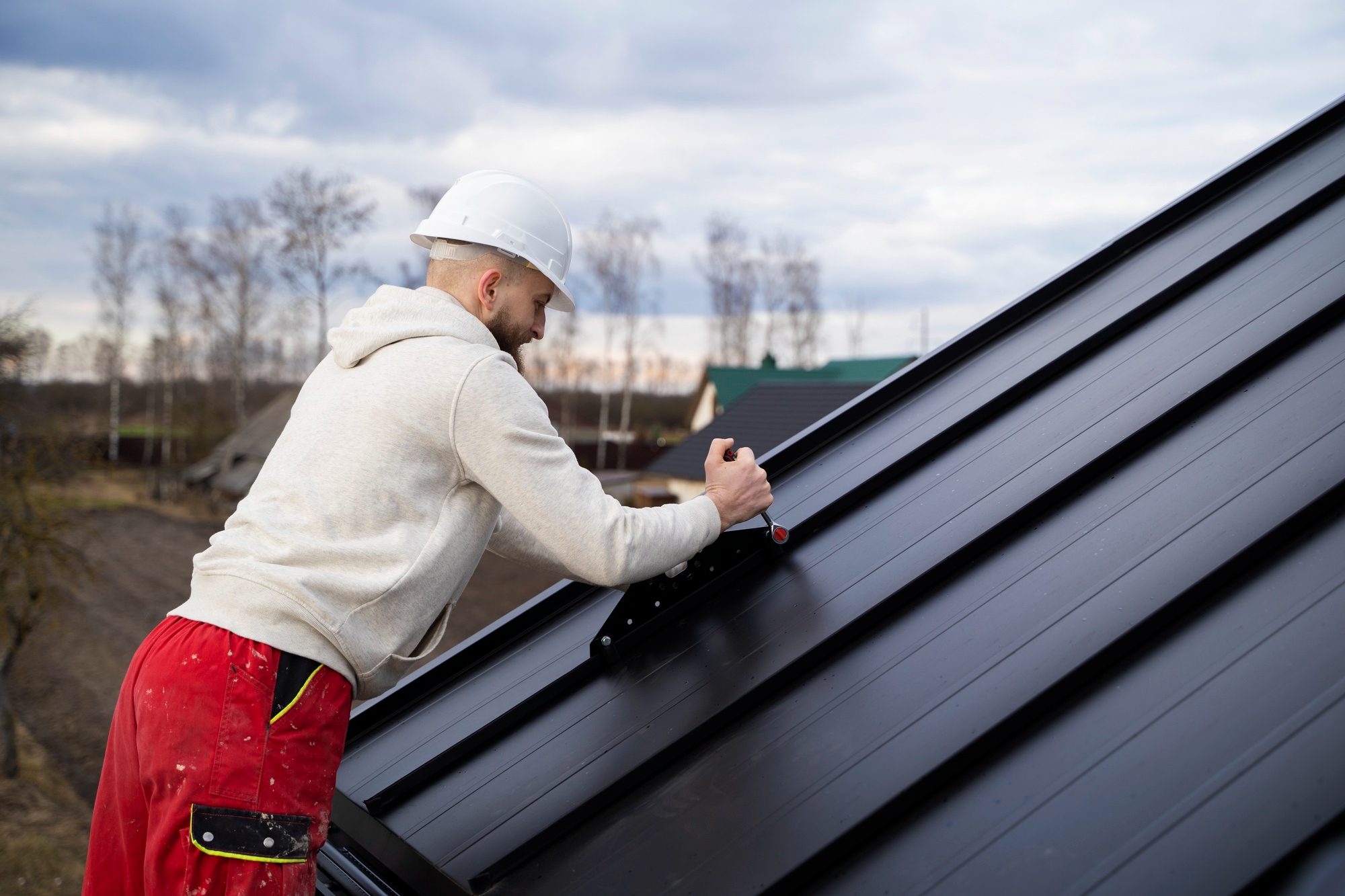 Man working on roof medium shot<br />
