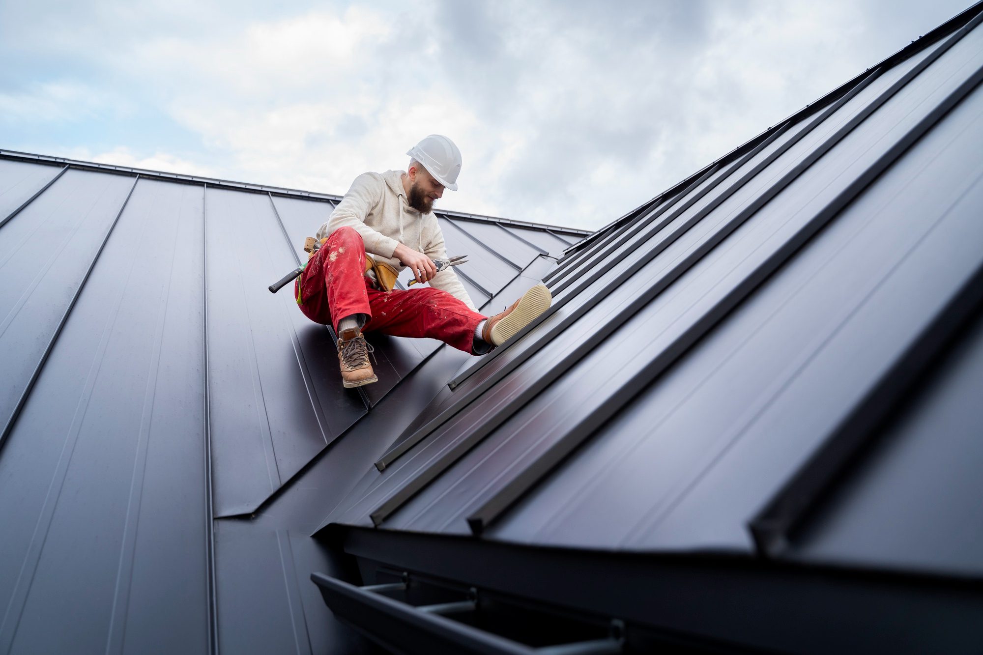 Full shot man working on roof<br />
